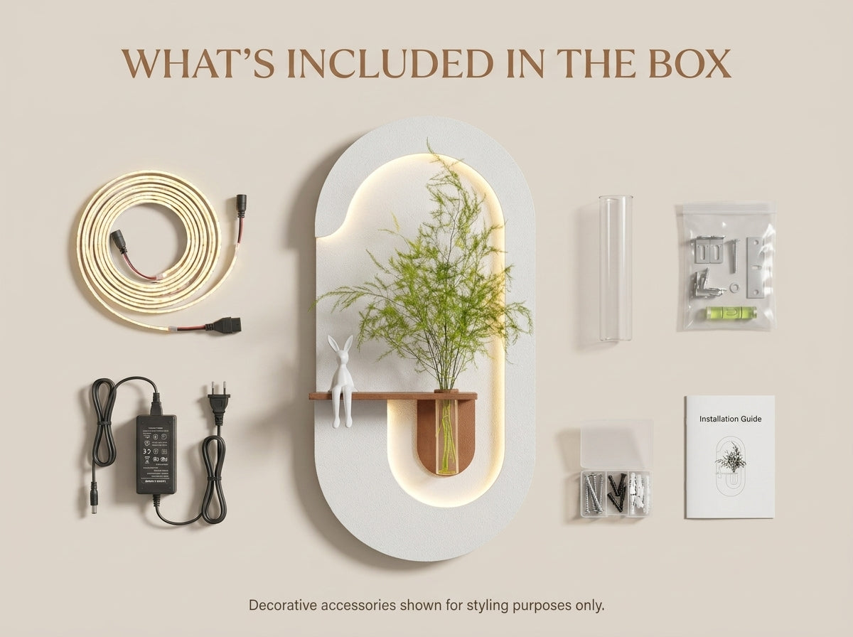 Product flat lay showing a modern oval wall-mounted shelf or decor unit with built-in LED lighting, a small wooden shelf, and a potted bamboo plant, alongside included accessories: a coiled cable, power adapter, clear tubes, hardware, and a small instruction booklet. Text at the top reads 'WHAT'S INCLUDED IN THE BOX' on a warm beige background.